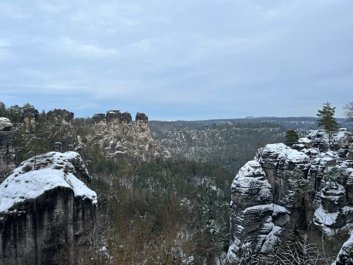 Snow-dusted sandstone towers in the Bastei rock area of Saxon Switzerland