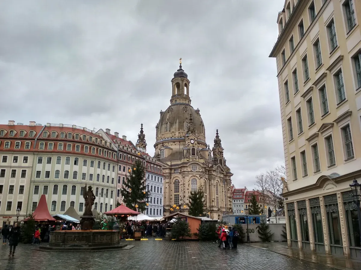 Dresden Frauenkirche rising over the Neumarkt Christmas market stalls