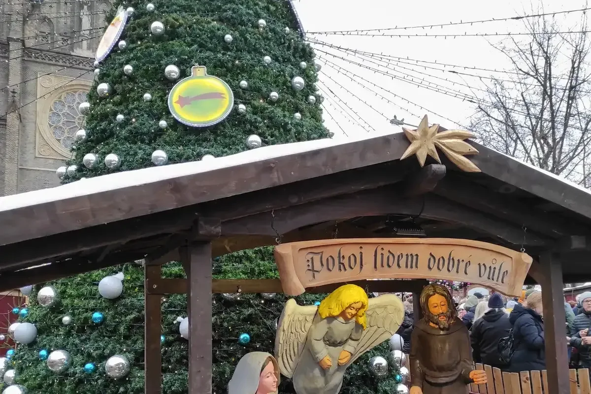 A nativity scene in front of the decorated tree at the Náměstí Míru market, the first of the Prague Christmas markets to open