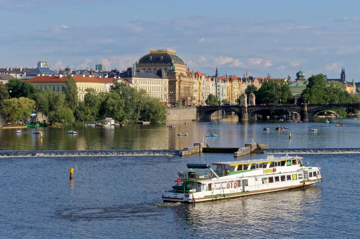 River cruise boat on the Vltava with the National Theatre behind