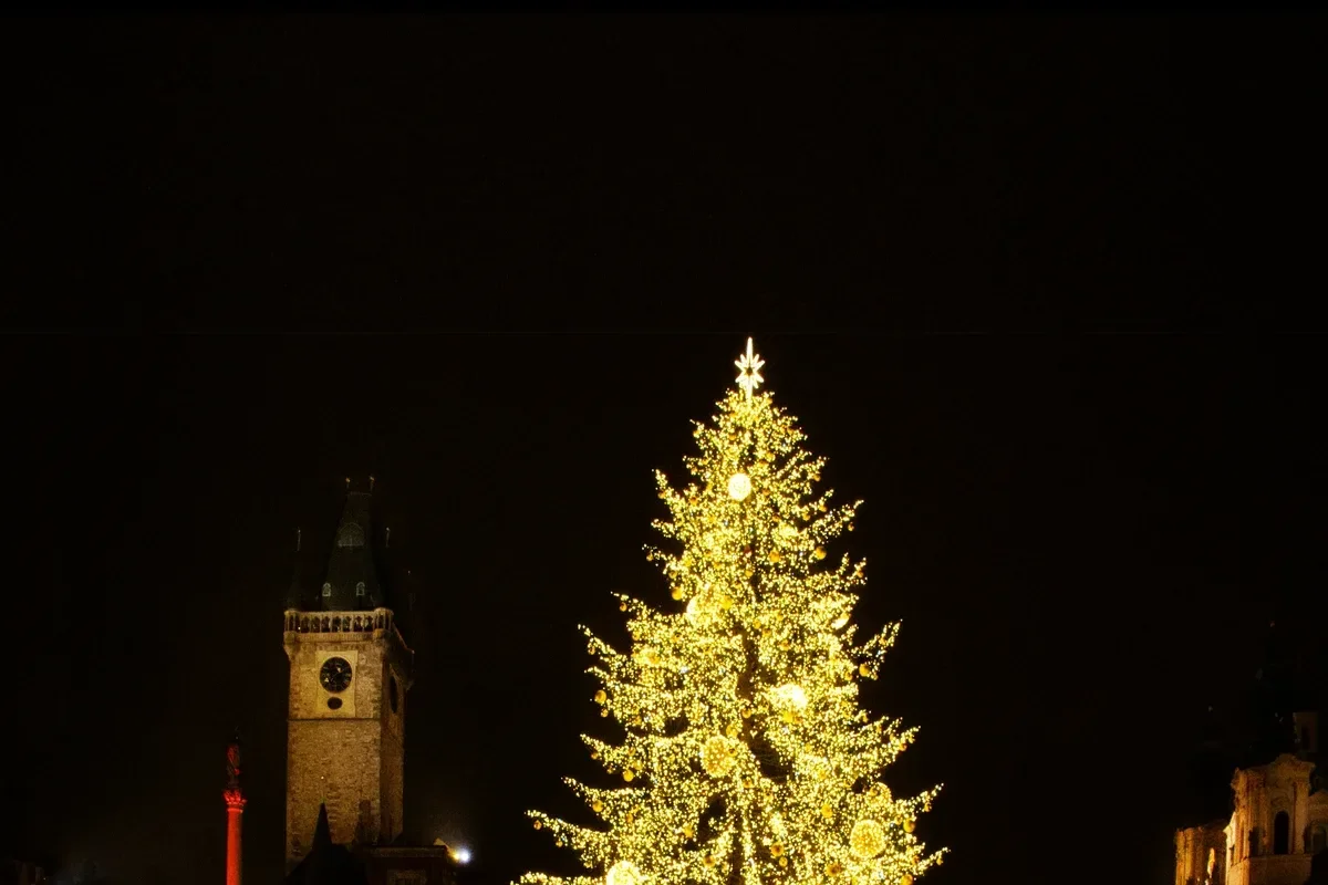 The lit Christmas tree on Old Town Square, where the market still runs on Prague New Year's Eve