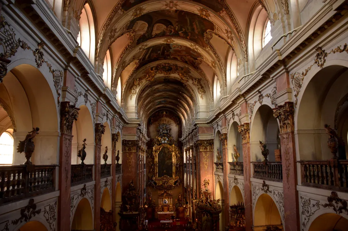 Baroque nave and vaulted ceiling of St. James Basilica in Prague's Old Town