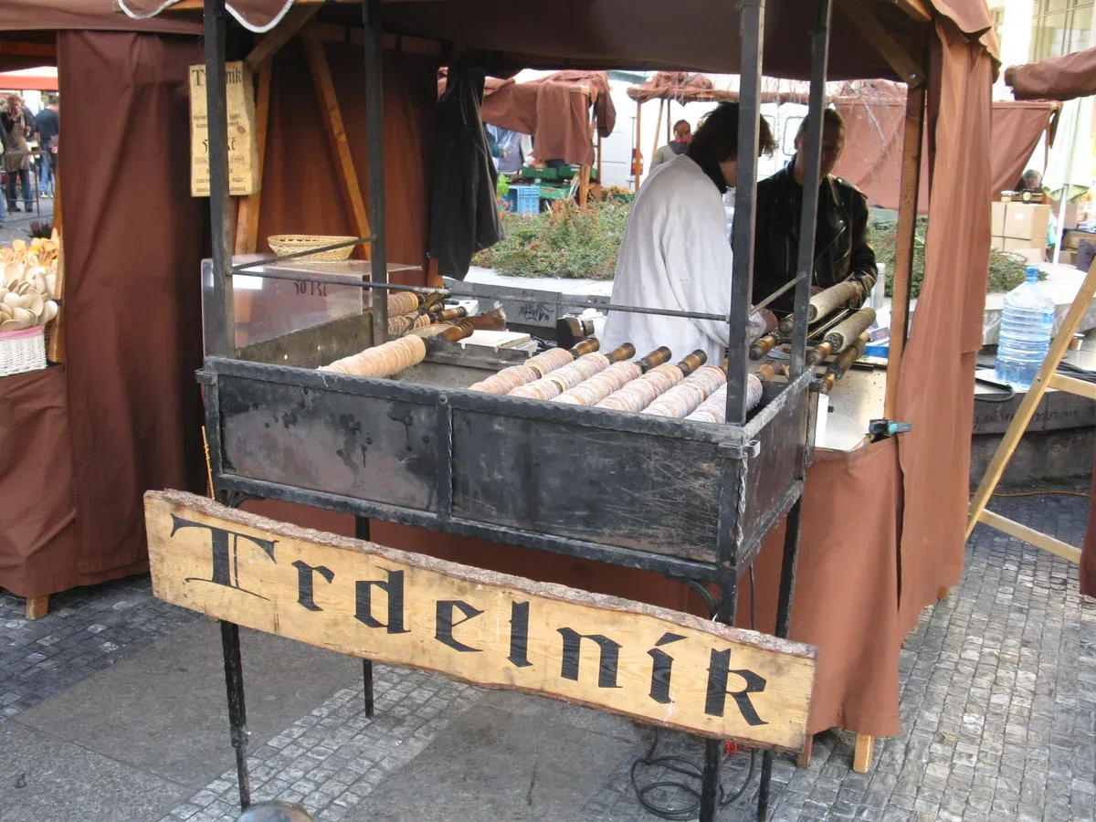 Trdelník stall with rolls turning over the coals on Náměstí Republiky in Prague