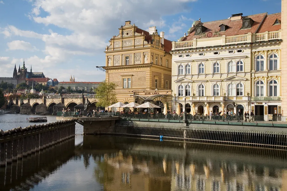 Vltava embankment in Prague's Old Town with Prague Castle in the distance